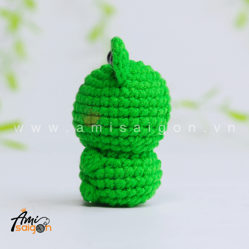 Cute frog amigurumi facing forward with black eyes and a sweet handmade crochet look
